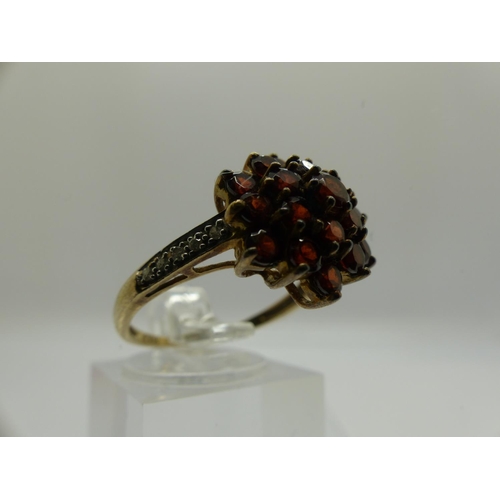 69 - 9ct gold cluster ring set with garnets and diamond set shoulders, size P, 2.8g. UK P&P Group 0 (£6+V... 