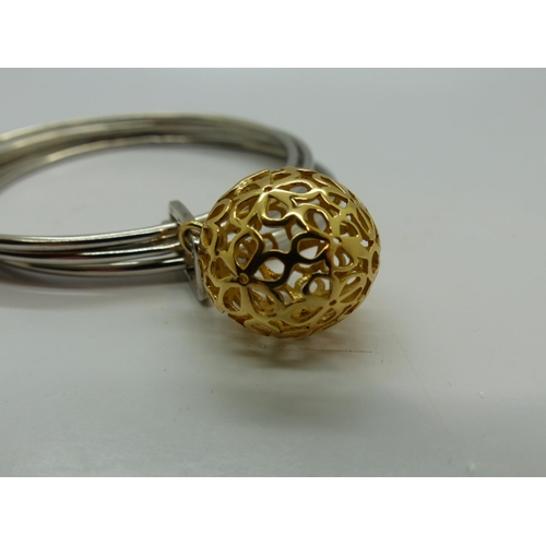 118 - White metal bangle with gold plated circular charm, D: 70mm. UK P&P Group 0 (£6+VAT for the first lo... 