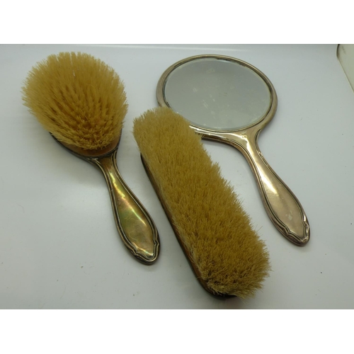 189 - Hallmarked silver mirror and brushes, mirror L: 27 cm. UK P&P Group 2 (£20+VAT for the first lot and... 