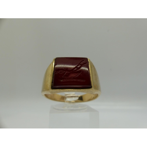 62 - 9ct gold signet ring, set with a carved carnelian intaglio displaying a plough, size U, 7.8g. UK P&P... 