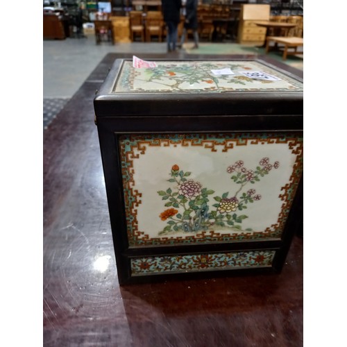 367 - Oriental metal bound tiled box with wooden interior, top tile cracked, 16 x 16 x 20 cm. Crack across... 