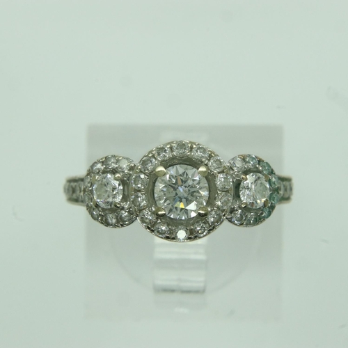 72 - 14ct gold diamond set ring, with central stone (0.25ct) flanked by further diamonds and an aquamarin... 