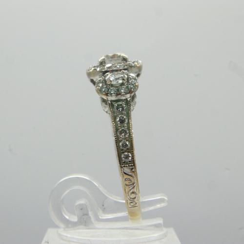 72 - 14ct gold diamond set ring, with central stone (0.25ct) flanked by further diamonds and an aquamarin... 