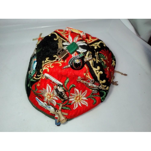 1094 - Tirol embroidered cap with badges and an enamel example. UK P&P Group 1 (£16+VAT for the first lot a... 