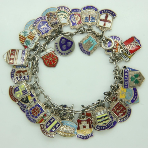 34 - Silver charm bracelet with forty charms, 60g. UK P&P Group 1 (£16+VAT for the first lot and £2+VAT f... 
