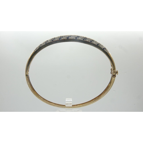 71 - 9ct gold diamond and sapphire bangle, D: 62 mm, 10.3g. UK P&P Group 1 (£16+VAT for the first lot and... 