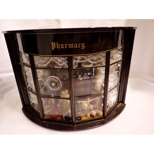 1063 - Wooden cased pharmacy diorama. Not available for in-house P&P