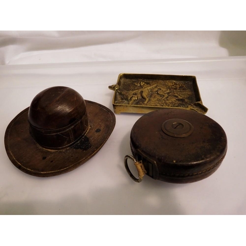 1090 - Wooden cowboy hat inkwell, lacking stopper, brass ashtray and a Finches leather cased tape. UK P&P G... 