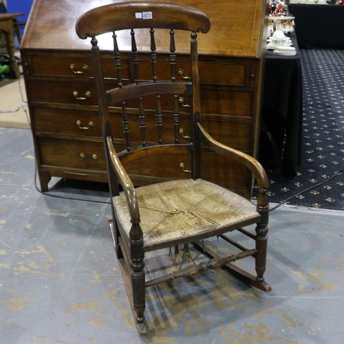 2073 - A 19th century country elm rocker, with rushed seat and turned spindle back. Not available for in-ho... 