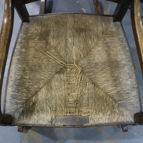 2073 - A 19th century country elm rocker, with rushed seat and turned spindle back. Not available for in-ho... 