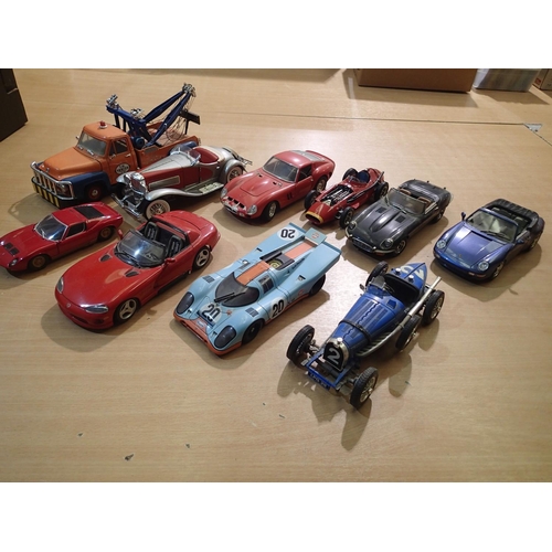 2418 - Ten mostly 1/18 scale diecast cars, trucks, racing cars, all ex display, some missing parts, unboxed... 