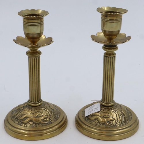 404 - Pair of brass candlesticks with hunting scenes impressed, T&T reg number 65361, H: 17 cm. UK P&P Gro... 