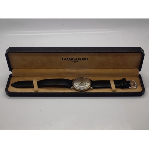 66 - LONGINES: gents automatic wristwatch with silvered dial and date aperture on a black leather strap, ... 