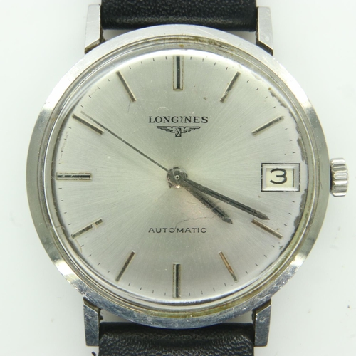 66 - LONGINES: gents automatic wristwatch with silvered dial and date aperture on a black leather strap, ... 