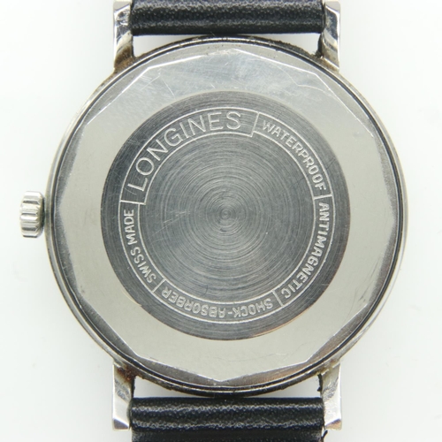 66 - LONGINES: gents automatic wristwatch with silvered dial and date aperture on a black leather strap, ... 