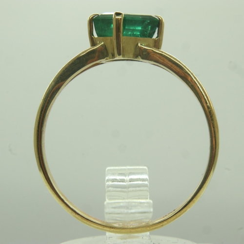 16 - 18ct gold emerald-set solitaire ring, the stone emerald-cut in a split setting, size O/P, 2.4g. UK P... 