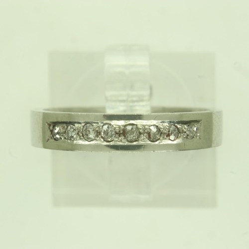 22 - Contemporary platinum band ring, channel-set with eight diamonds, size M/N, 5.4g. UK P&P Group 0 (£6... 