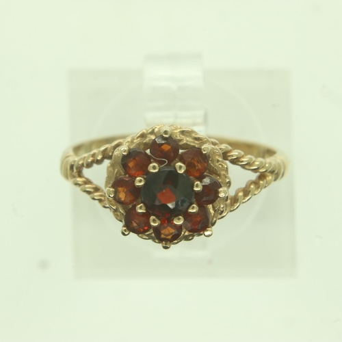 35 - 9ct gold garnet set flower-head cluster ring, size J/K, 1.6g. UK P&P Group 0 (£6+VAT for the first l... 