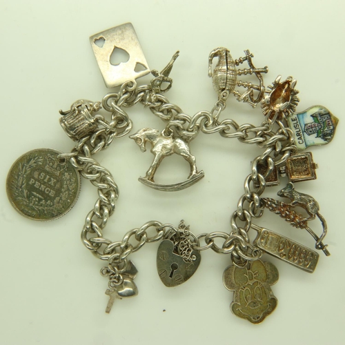 39 - 925 silver charm bracelet with thirteen charms, L: 22 cm, 33g. UK P&P Group 0 (£6+VAT for the first ... 