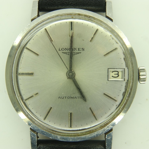 66 - LONGINES: gents automatic wristwatch with silvered dial and date aperture on a black leather strap, ... 