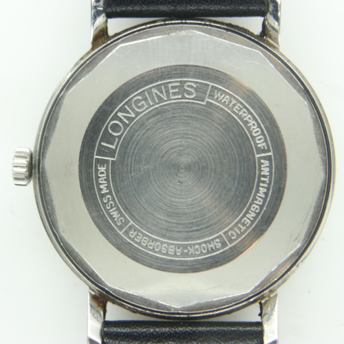 66 - LONGINES: gents automatic wristwatch with silvered dial and date aperture on a black leather strap, ... 