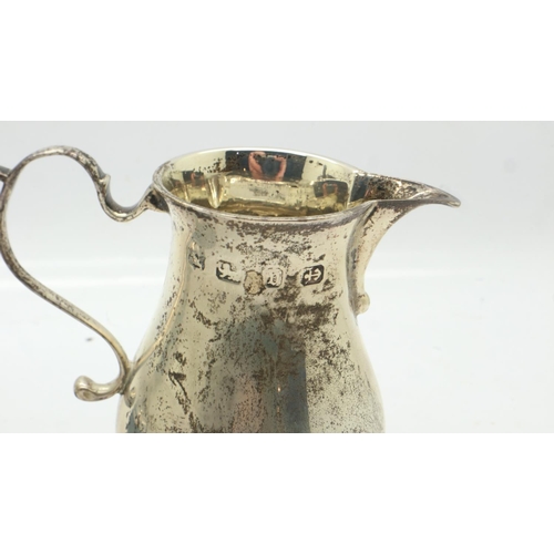 91 - Hallmarked silver cream jug and a miniature silver trophy, combined 117g. UK P&P Group 1 (£16+VAT fo... 