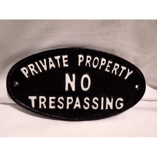 1034 - Cast iron oval No Trespassing sign, L: 24 cm. UK P&P Group 1 (£16+VAT for the first lot and £2+VAT f... 