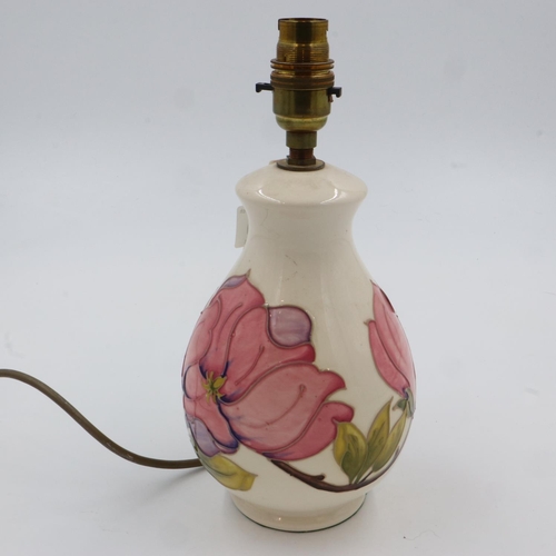 179 - Cream ground Moorcroft table lamp base in the Pink Magnolia pattern, H: 28 cm, has hairline crack do... 