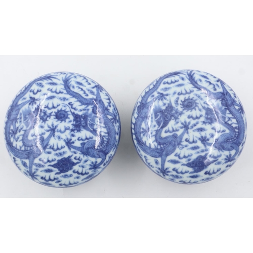 260 - Pair of Chinese blue and white covered bowls with dragon decoration, each raised on a wooden stand, ... 