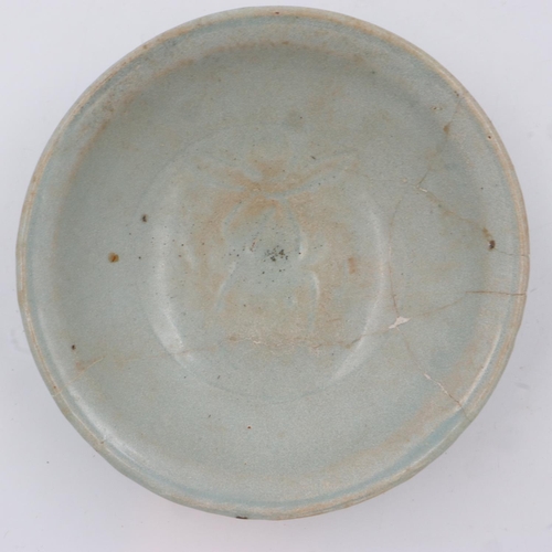 265 - A celadon glazed porcelain bowl having incised decoration to its interior and a footed base, D: 17 c... 