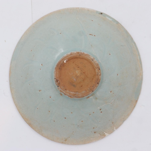 265 - A celadon glazed porcelain bowl having incised decoration to its interior and a footed base, D: 17 c... 