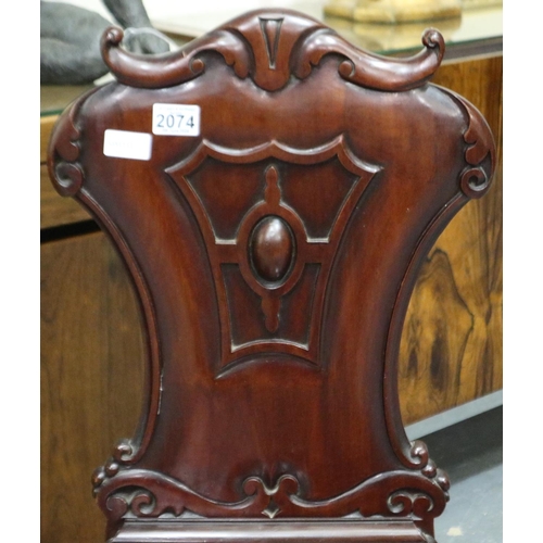 2074 - A 19th century mahogany hall chair with carved backrest and serpentine front seat. Not available for... 