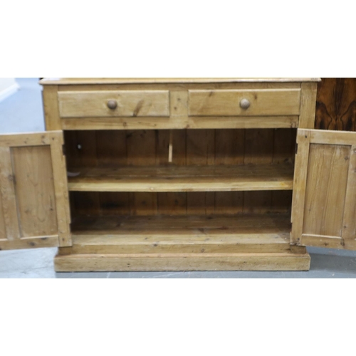 2075 - A Victorian country pine sideboard of two drawers and two cupboard doors having a two-tier shelved u... 