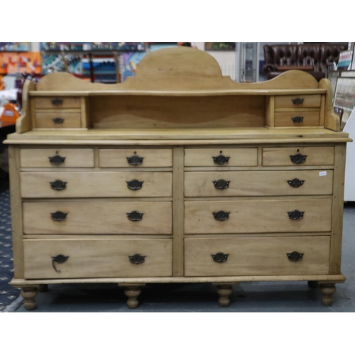 2076 - A Victorian pine oversized chiffonier of ten drawers, raised upstand with four short drawers and ove... 