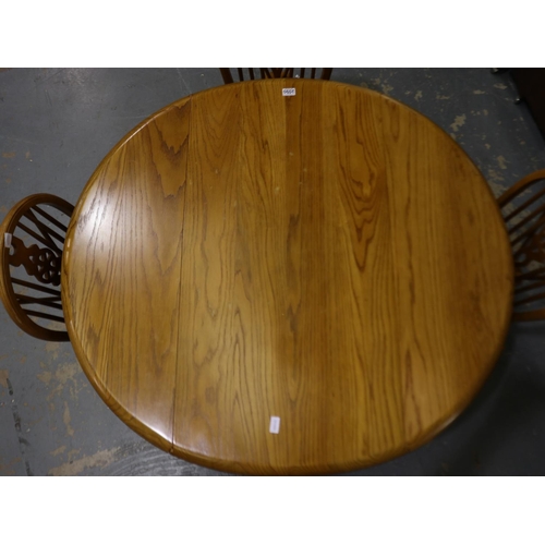 2090 - A mid 20th century golden oak drop leaf dining table, 128x117x76cm H, some small water marks to top,... 