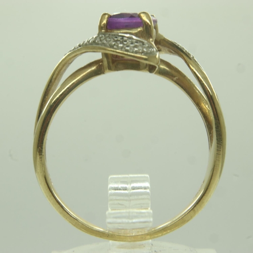 11 - 9ct gold amethyst and diamond crossover ring, size P, 3.4g. UK P&P Group 0 (£6+VAT for the first lot... 