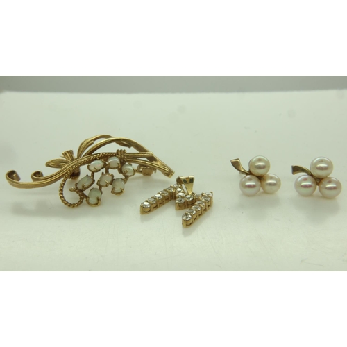 12 - A pair of 9ct gold stud earrings, each set with three pearls in the form of three-leaf clovers, comb... 