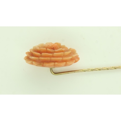 13 - 9ct gold stick pin, mounted with a large panel of carved coral, L: 70 mm, 2.8g. UK P&P Group 0 (£6+V... 