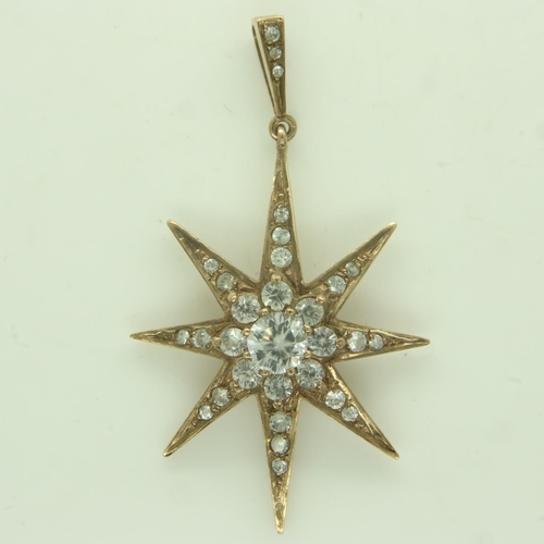 14 - An Edwardian 9ct gold star-form pendant, set with graduating white sapphires, drop L: 48 mm, 5.8g. U... 