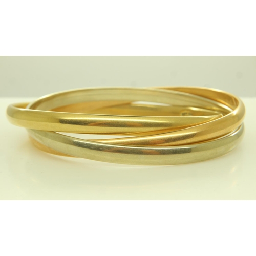 16 - An 18ct tri-gold suite of three interlocking bangles, each D: 70 mm, 46.4g. UK P&P Group 1 (£16+VAT ... 