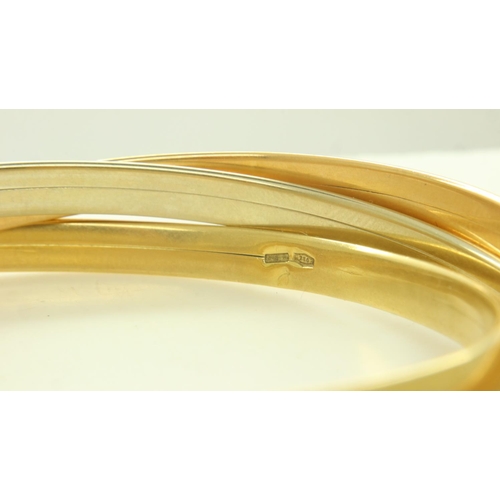 16 - An 18ct tri-gold suite of three interlocking bangles, each D: 70 mm, 46.4g. UK P&P Group 1 (£16+VAT ... 