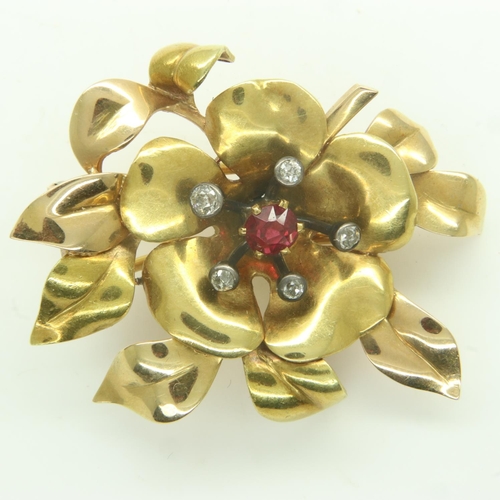 40 - A continental 18ct gold brooch, of floral design with raised old-cut diamonds and central ruby, twin... 