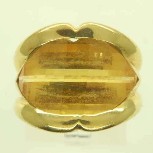 46 - A wide profile 18ct gold ring, set with a large channel-set faceted citrine, size M, 10.7g. Small ch... 