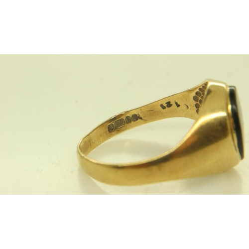 50 - Two 9ct gold rings: decorated band ring size P, 2.9g and an onyx-set signet ring, shank mis-shapen, ... 