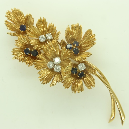 51 - BOUCHERON (Paris): an 18ct gold brooch, floral design set with diamonds and sapphires, twin-pin, sig... 