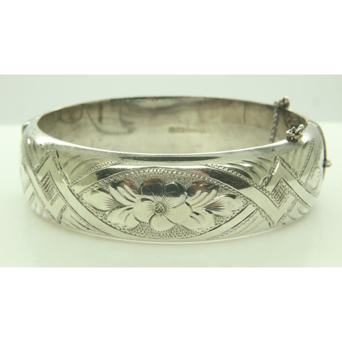 74 - A hallmarked silver snap bangle, hinged with safety chain, 41g. UK P&P Group 0 (£6+VAT for the first... 