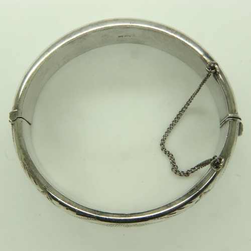 74 - A hallmarked silver snap bangle, hinged with safety chain, 41g. UK P&P Group 0 (£6+VAT for the first... 