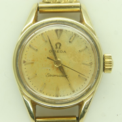 95 - OMEGA: Seamaster ladies wristwatch, gold-plated steel case on an 18ct gold bracelet, champagne circu... 