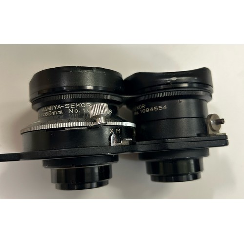 324A - Mamiya C33 professional camera with Mamiya Sekar 1:4.5 F=135mm lenses number 727948 and 702319, and ... 