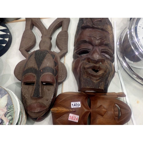 1409 - Three African carved masks. Not available for in-house P&P